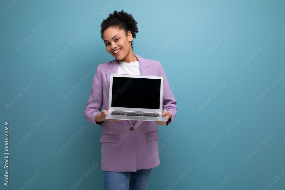 young pretty brunette office woman dressed in a jacket demonstrates laptop screen mockup young pretty brunette office woman dressed in a jacket demonstrates laptop screen mockup