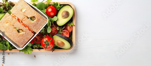 Healthy lunch box with sandwich and vegetables on office table Top view Flat lay. Website header. Creative Banner. Copyspace image photo