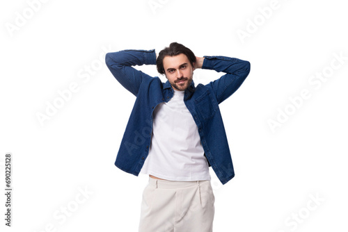 handsome young brunette man in a denim shirt on a white background