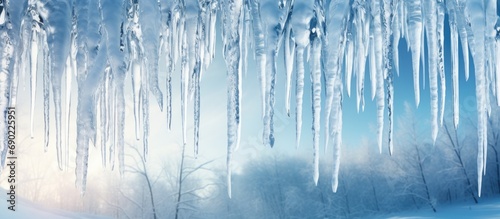 Huge icicles hang from the facades of buildings The fall of icicles carries a danger to people s lives. Website header. Creative Banner. Copyspace image