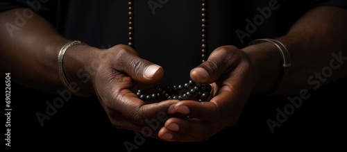 Prayer rosary and hands of black man for worship faith and belief for support help and hope Religion praying and christian person in home for meditation spiritual healing and trust for praise photo
