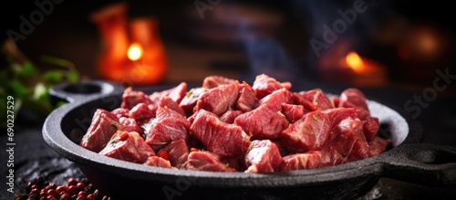 Fresh raw diced red beef meat on cast iron plate Selective Focus Focus one third into the meat. Website header. Creative Banner. Copyspace image
