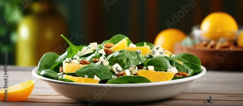 Fresh spinach salad with oranges feta ricotta cheese red onion and pine nuts. Website header. Creative Banner. Copyspace image