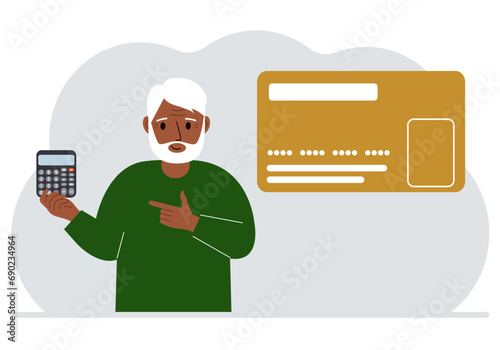 A man holds a calculator in his hand. Nearby is a large plastic card.