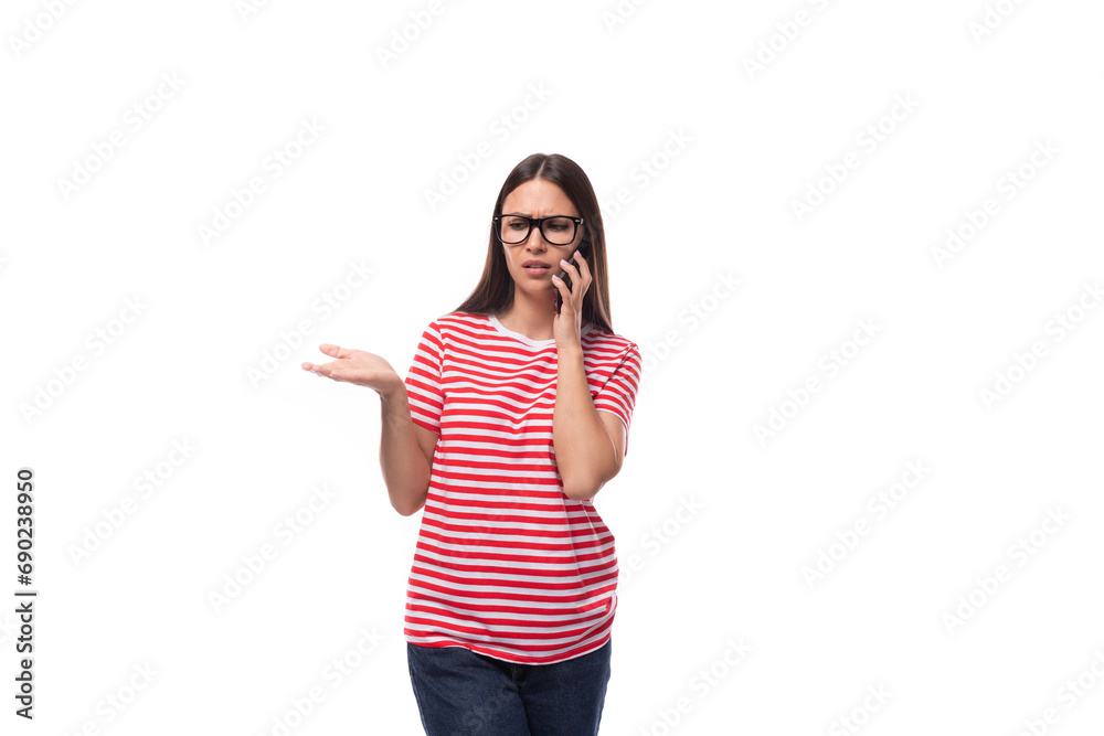 successful pretty 35 year old european lady in glasses for vision and a red striped t-shirt sort things out on the phone successful pretty 35 year old european lady in glasses for vision and a red striped t-shirt sort things out on the phone