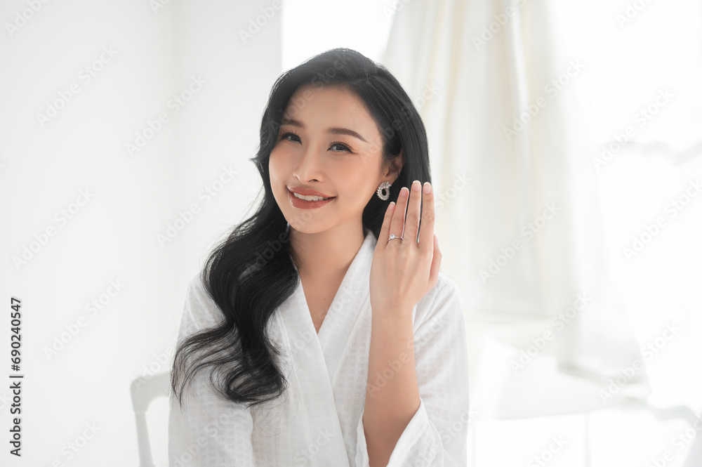 Bride in White bathrope with elegant diamond ring preparing for wedding day, Love and marriage concept Bride in White bathrope with elegant diamond ring preparing for wedding day, Love and marriage concept
