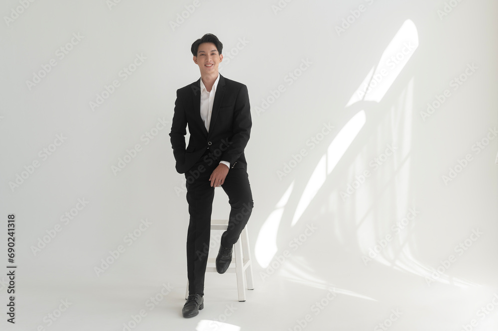 Fototapeta premium Portrait of young handsome groom in suit, preparing for wedding ceremony
