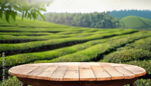 Empty wooden table with tea plantation nature background