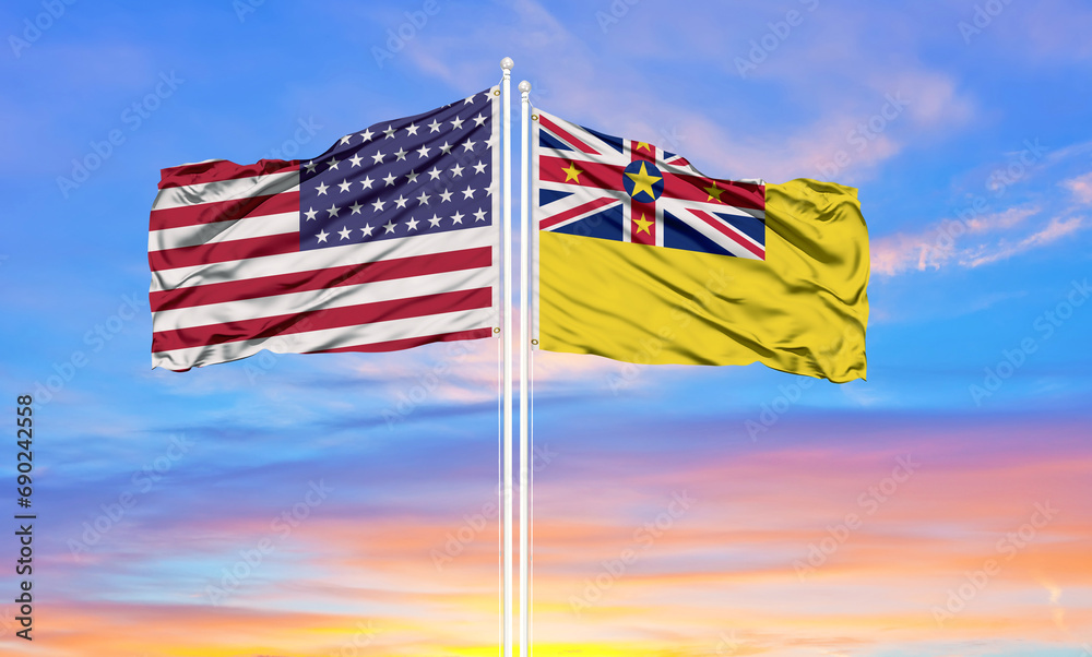 United States and Niue two flags on flagpoles and blue cloudy sky . Diplomacy concept, international relations