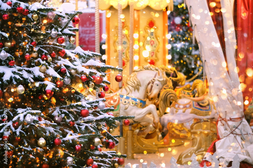 Christmas holiday background. Beautiful decorated Christmas tree and horse carousel on traditional Christmas market. Christmas and New Year concept. festive winter season.