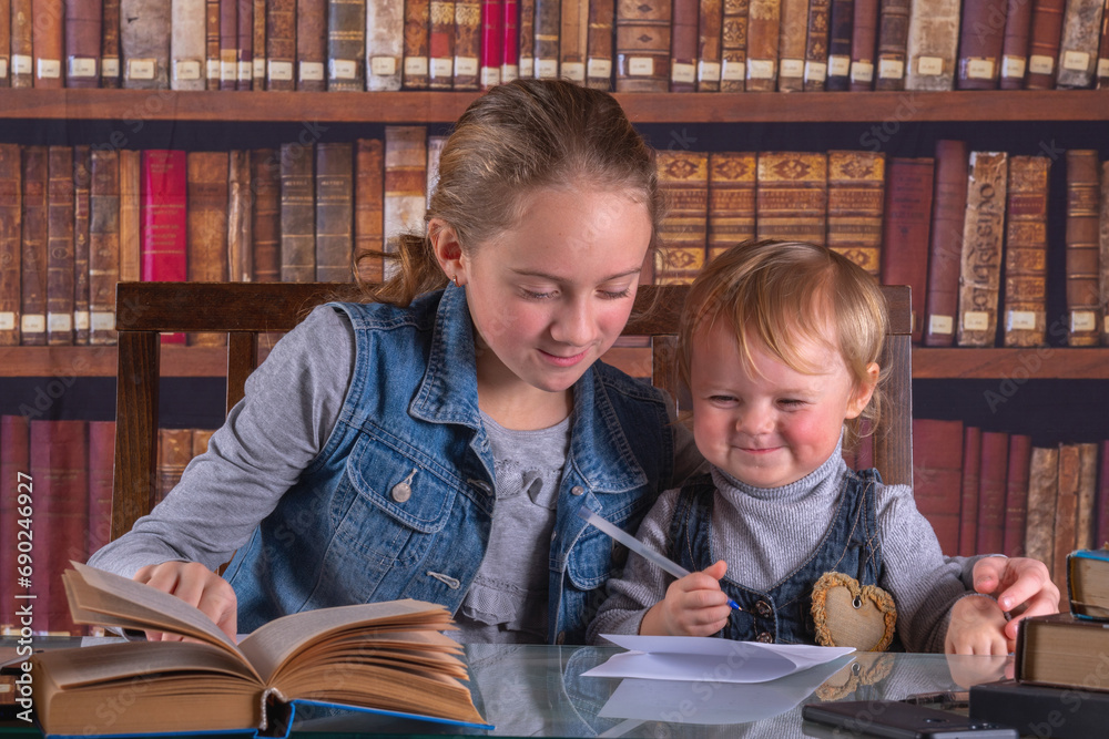Conceptual image: child development and early learning. Funny portrait of young scientists studying and reading books in the library. Conceptual image: child development and early learning. Funny portrait of young scientists studying and reading books in the library.