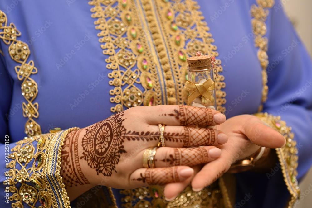 mehendi on the hands of girls,Woman Hands with black mehndi tattoo. Hands of moroccan bride girl with black henna tattoos