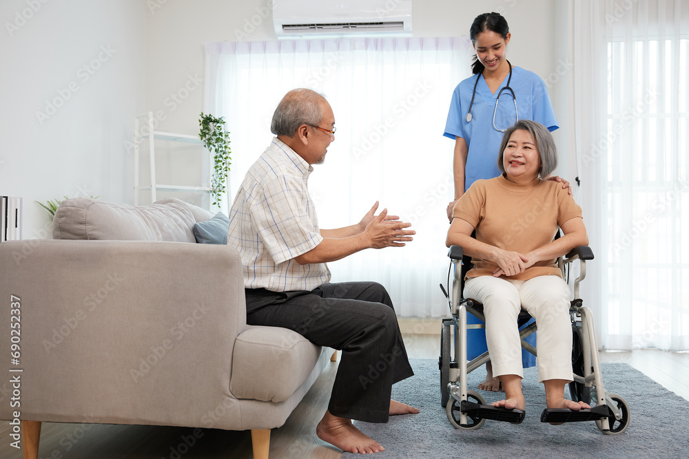 nurse or caregiver helping senior woman sitting on wheelchair and senior man support her at home nurse or caregiver helping senior woman sitting on wheelchair and senior man support her at home