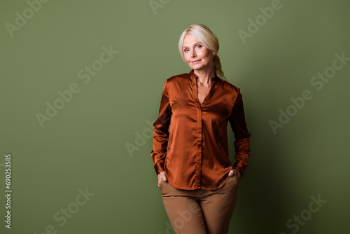 Photo portrait of lovely senior lady representative agent model dressed stylish silk brown garment isolated on khaki color background © deagreez