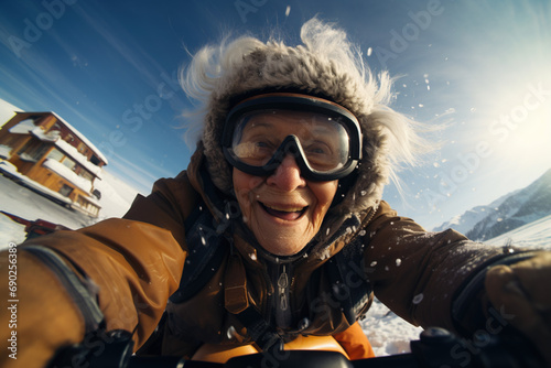Active sport elderly healthy lifestyle concept. Senior active smiling mature female woman selfie portrait snowboarding skiing in glasses look happy on top of mountains winter day time, happily retired
