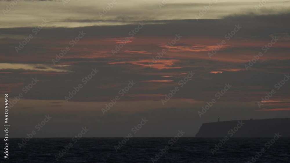 Serene Dusk at the Lighthouse with Red Sky and Waves Serene Dusk at the Lighthouse with Red Sky and Waves