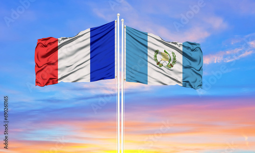 france and Guatemala two flags on flagpoles and blue cloudy sky . Diplomacy concept, international relations