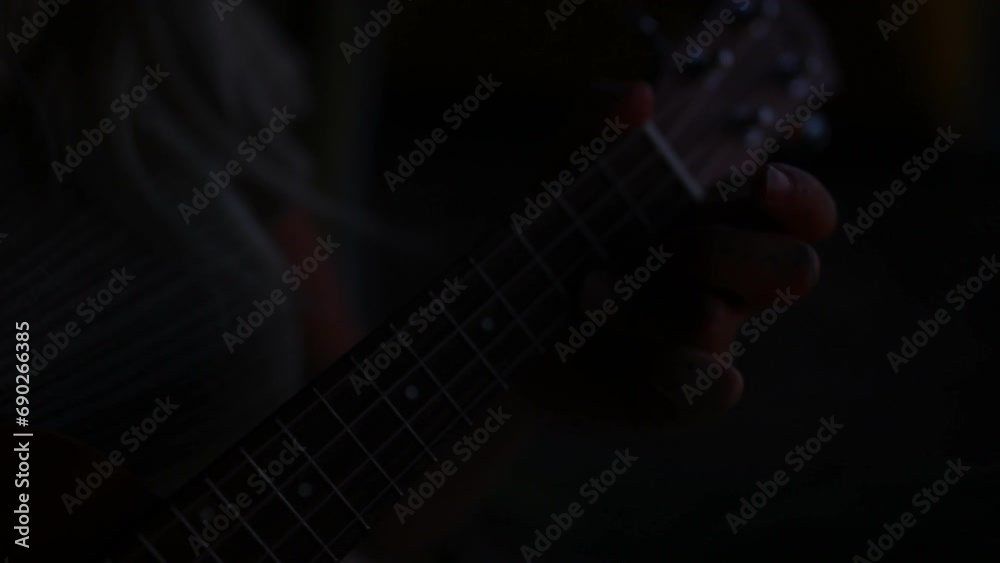 Hands, playing and guitar at night for music, sound and relax outdoor on vacation or holiday location. Person, musician or instrument and acoustic, freedom and guitarist in dark for adventure or fun