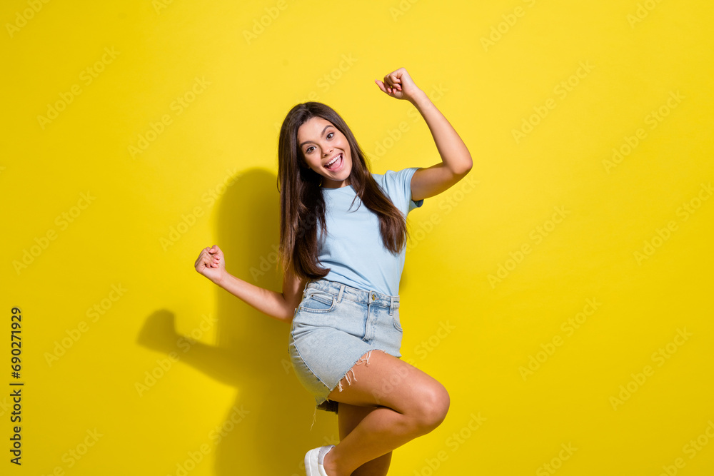 Naklejka premium Photo of positive cheerful girl celebrate winning in lottery raise fists up isolated over bright color background