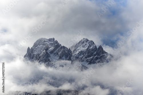 Snow covered peaks of the Sesto Dolomites with clouds in winter, mountains of the Alps, South Tyrol, Italy, Europe