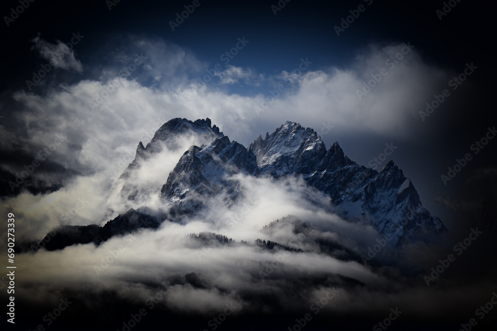 Snow covered peaks of the Sesto Dolomites with clouds in winter, mountains of the Alps, South Tyrol, Italy, Europe - obrazy, fototapety, plakaty 