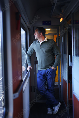 Canvas Print man stay into the train and look out from window