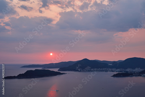 Pink sunset over a mountain range in the sea