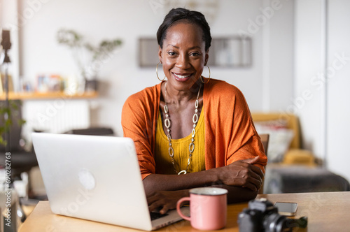 Mature woman working on laptop at home 