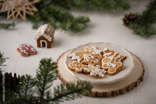 Composition with delicious homemade Christmas gingerbread cookies. Festive homemade decorated sweets with Christmas decorations and fir branches.