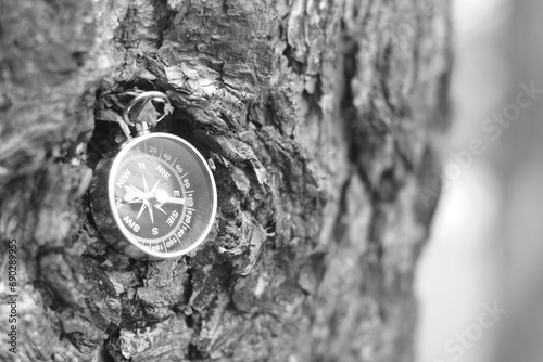 black and white photo of round compass