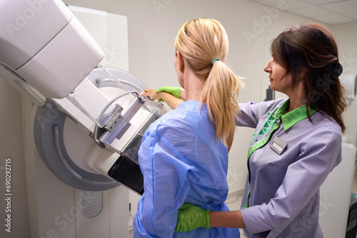 Caucasian woman being prepared for digital breast tomosynthesis photo