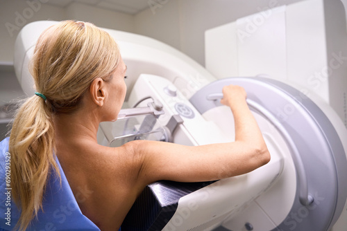Adult female patient receiving 3D mammography in clinic