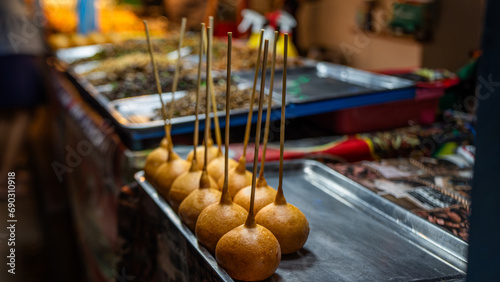 Desserts made from flour with filling Fry in a pan with very hot oil. Until it swells into a circular shape at the end of the stick. It tastes sweet and oily. Popularly sold at temple events. photo