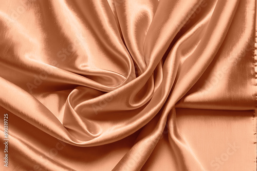 Abstract background luxurious fabric, wavy folds of silk texture. Trendy colors of 2024 - peach fuzz