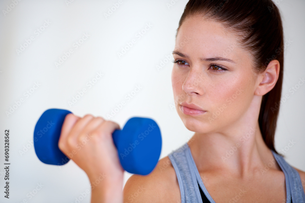 Woman, serious and exercise with dumbbells in studio, health wellness and fitness for weight loss. Young person, thinking or commitment with workout for tone muscle or training on white background Woman, serious and exercise with dumbbells in studio, health wellness and fitness for weight loss. Young person, thinking or commitment with workout for tone muscle or training on white background