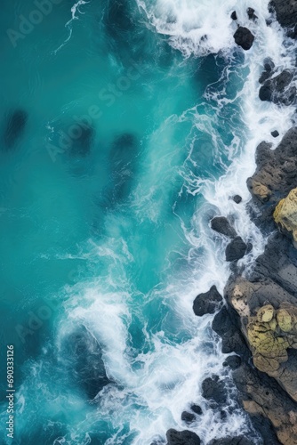 Aerial view of the ocean with rocks in the foreground, shot with drone, generated with AI © sch_ai