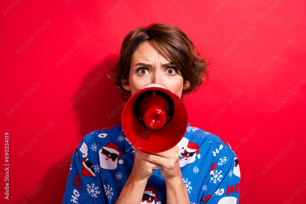 Obraz premium Photo of funny young girl screaming megaphone announcement she hate new year parties stop celebrating now isolated on red color background