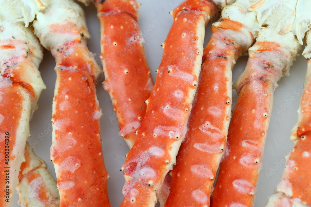 frosted Alaska king crab legs closeup photo on white table background frosted Alaska king crab legs closeup photo on white table background