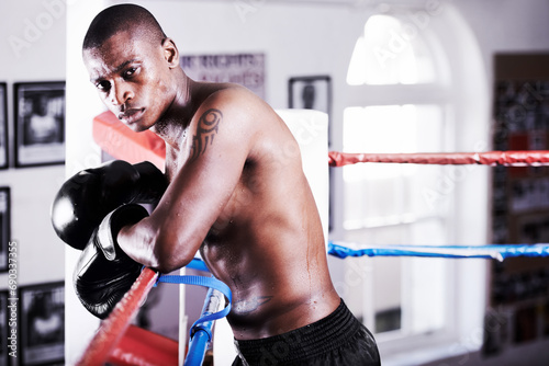 Boxing, confidence and portrait of black man in ring with fitness, power and workout challenge at sports club. Strong body, face of athlete or boxer in gym with sweat and gloves in competition fight.