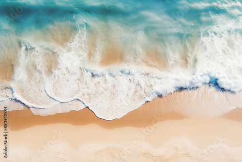 Aerial view of a shoreline with waves crashing onto the beach, the clear distinction between sea foam and golden sands illustrating the dynamic interface of land and sea.

 photo