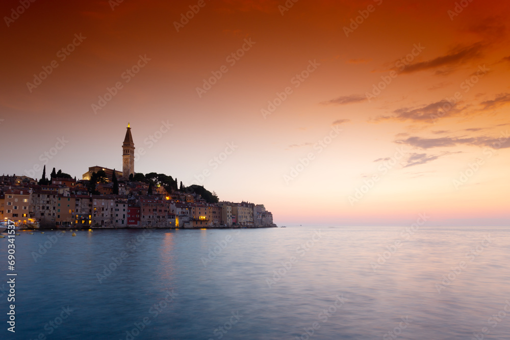 morning view of old  Rovinj town with multicolored buildings and yachts moored along embankment, Croatia.