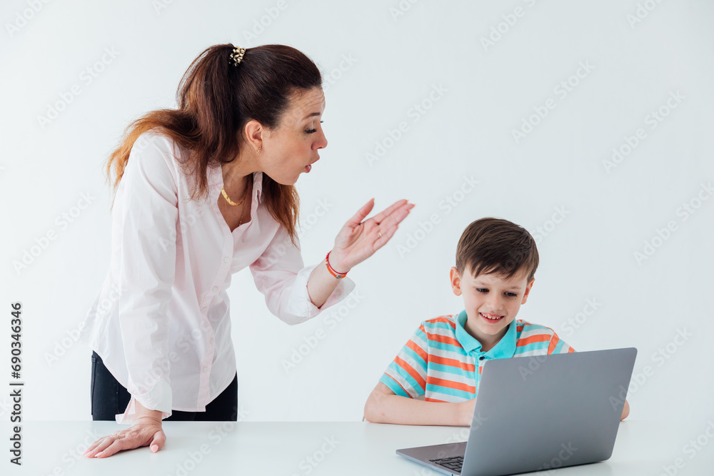 Woman teaching boy to work on computer online Woman teaching boy to work on computer online