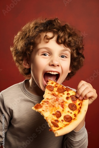 Funny child boy eating slice of pizza
