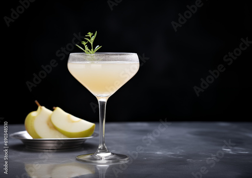 A sparkling pear mocktail, presented with understated grace on a polished black marble surface.