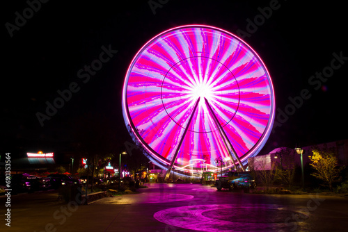 Glowing Ferris Wheel in Motion at Gatlinburg Nighttime Amusement Park