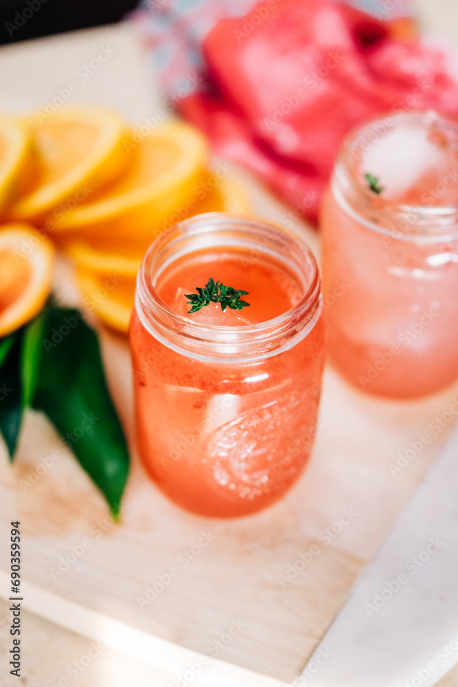 Mason Jar Mixology: Refreshing Orange and Blood Orange Drink with Citrus Medley Background Mason Jar Mixology: Refreshing Orange and Blood Orange Drink with Citrus Medley Background
