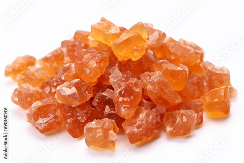 Heap of orange, amber colored raw dried gum arabic pieces on white background photo