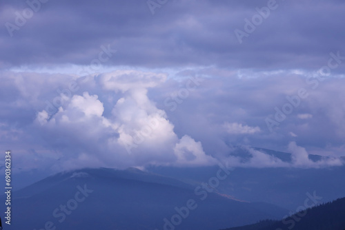 Morning view from the Dragobrat mountain peaks in Carpathian mountains, Ukraine. Cloudy and foggy landscape around Drahobrat Peaks in early morning