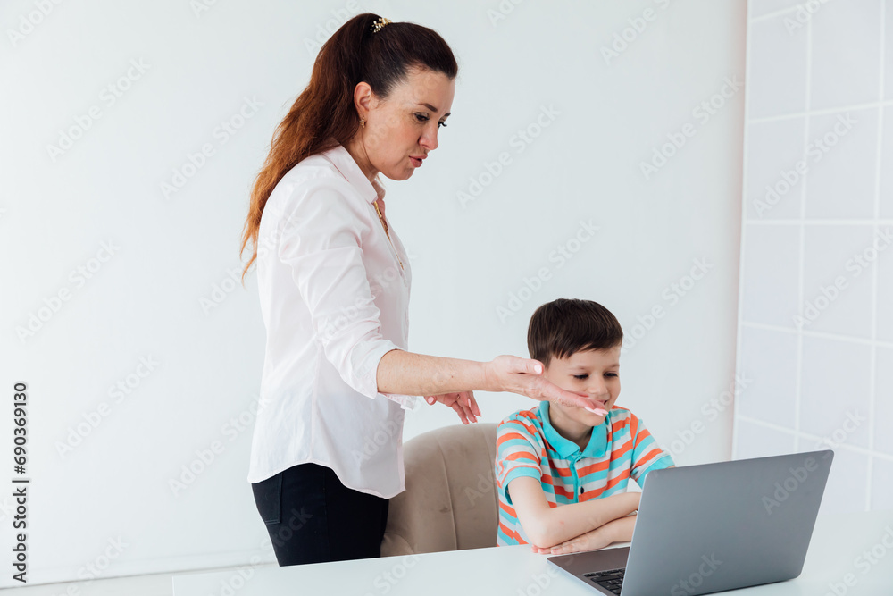 Female teacher teaches boy to work on computer online Female teacher teaches boy to work on computer online