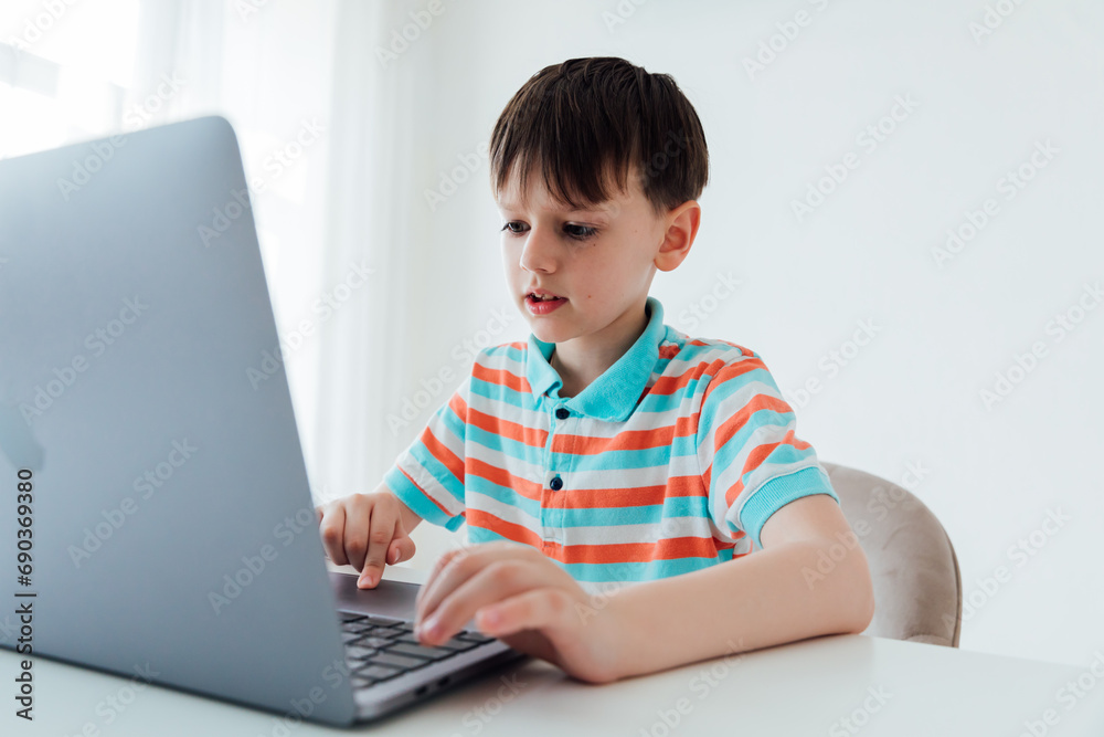 Boy working studying on laptop online at school Boy working studying on laptop online at school